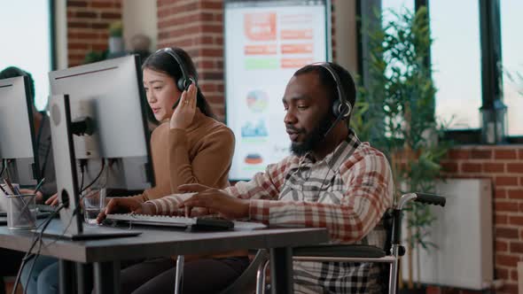 Male Operator Talking to Clients on Helpline at Call Center