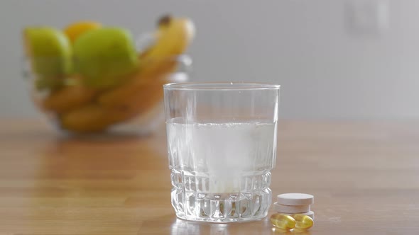 Close Up Glass with Water and Sparkling Pill. Magnesium Anti-stress, Painkiller or Orange Drink