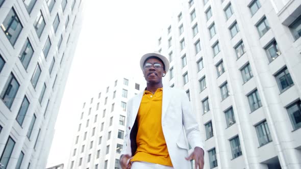 African American performer in white suit and yellow t shirt