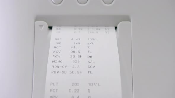The Slip Check With The Result of Laboratory Blood Tests Comes Out of The Laboratory Computer.