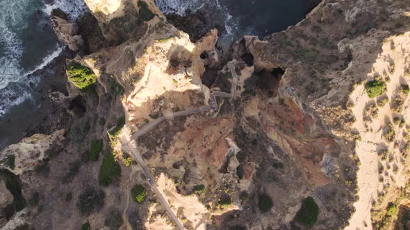 Majestic directly above view of limestone cliffs, rocky shore and ocean waves, Lagos, Algarve