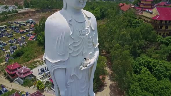 Flycam Shows White Buddha Statue Standing on Lotus Flower