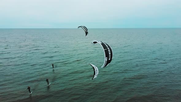 Aerial Drone View of a Corekites Kitesurfers Hydrofoiling  in Engure Port at in Baltic Sea