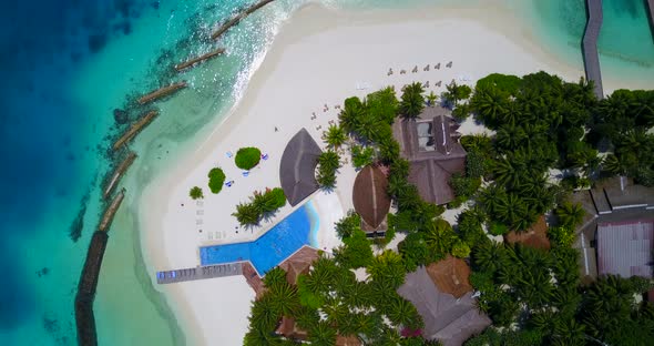 Daytime drone tourism shot of a white paradise beach and aqua blue water background in best quality 