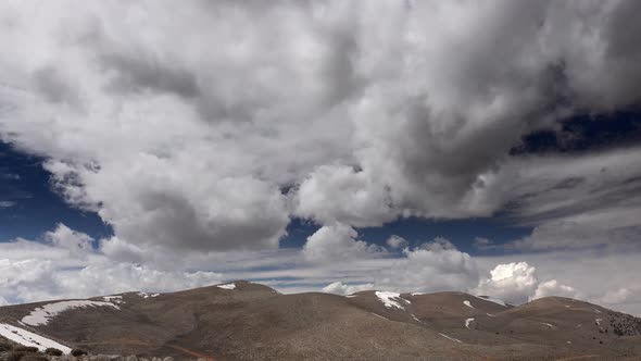 Partly Cloudy Sky Over Arid and Barren Treeless Mountain