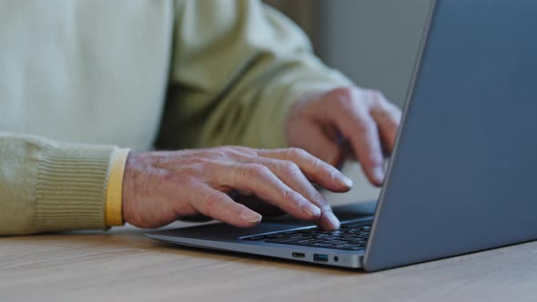 Closeup Hands Old Mature Man Write Text on Laptop Elderly Male Working Sitting at Table Communicates