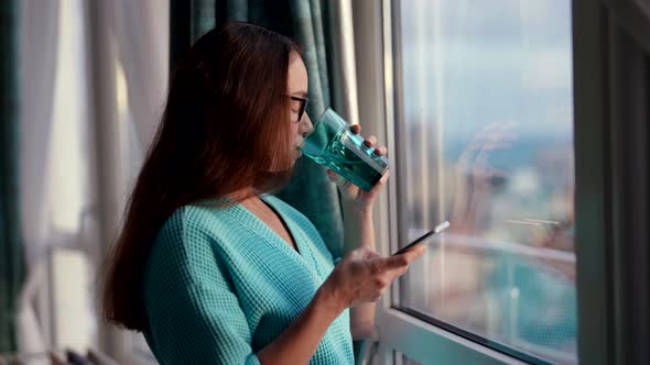 An Adult Attractive Woman Holding a Glass of Water to Drink on an Empty Stomach for Digestion Uses a