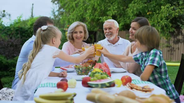 Healthy Cheerful Family Drinking Vitaminized Fresh Juice, Celebrating Traditions