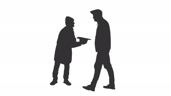 Silhouette of a Beggar Gets a Coin from a Man Walking by