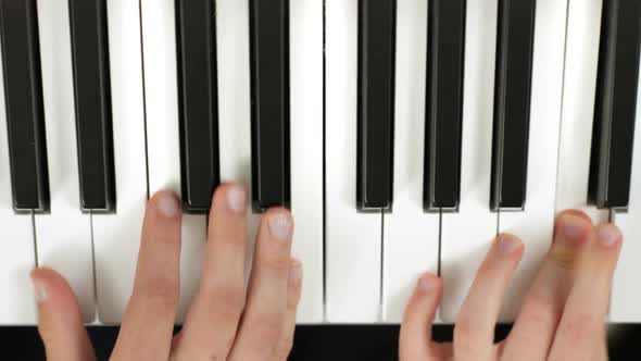 Brothers Playing in Tandem a Piano Partiture