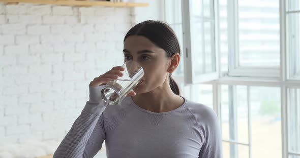 Young Fitness Athlete Woman Drinking Water After Sport Workout at Home