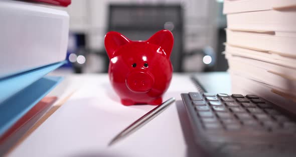 Red Piggy Bank Standing Near Documents and Calculator  Movie Slow Motion