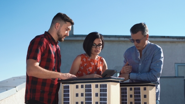 Team of Architects Discussing a High-rise Project