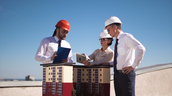 Three Architects or Engineers Having a Meeting