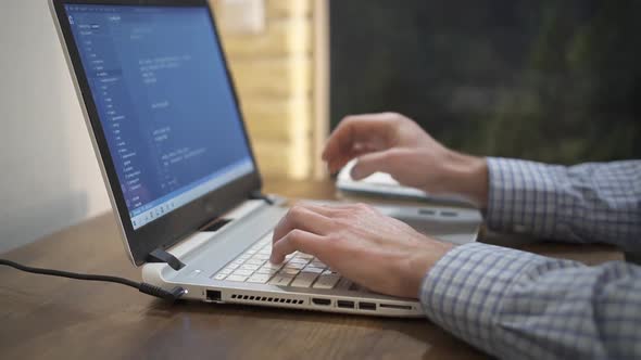 Computer Programmer Typing Code on Keyboard