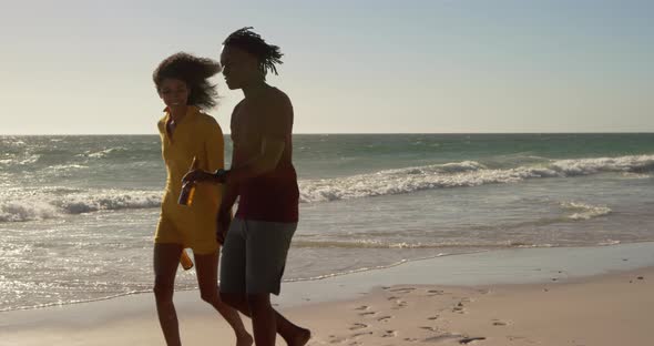 Couple walking together on the beach 4k