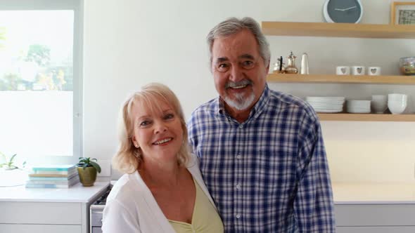 Portrait of couple standing in kitchen