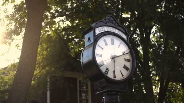 Old Street Vintage Clock In the Sun's Rays