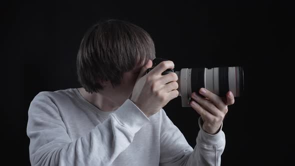 Photographer Taking Pictures On Dark Background