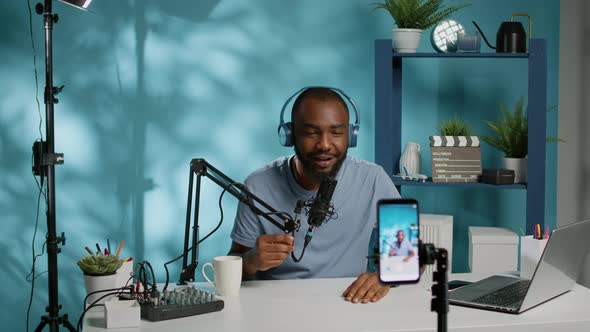 Blogger Waving at Smartphone Camera for Social Media Vlog