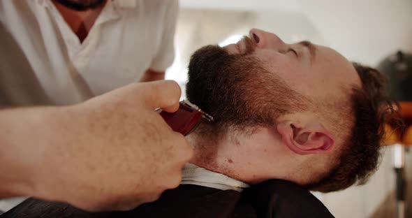 Handsome Man Getting New Hairstyle with Electric Trimmer