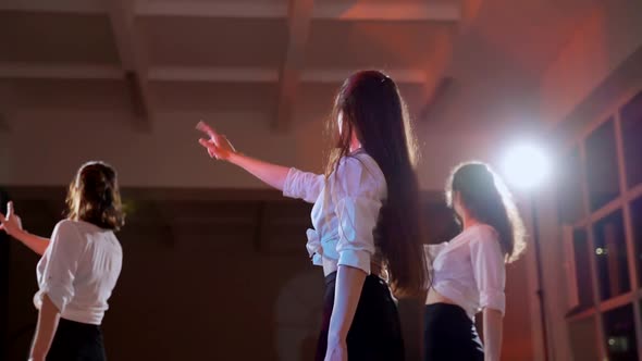 Four Girls in Black Skirts and White Shirts are Dancing Indoors