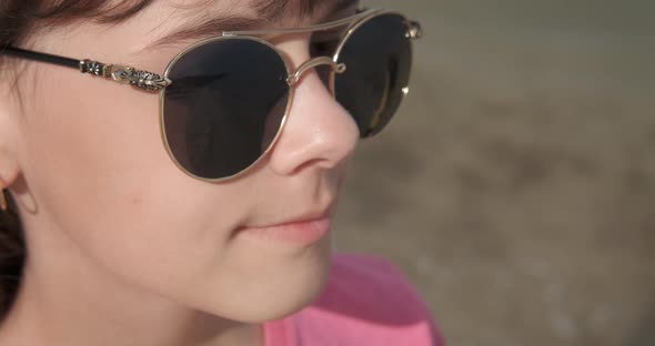 Relaxing Teen in Sunglasses on the Beach