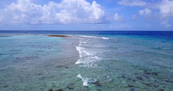 Tropical drone copy space shot of a white sandy paradise beach and blue sea background in hi res 4K