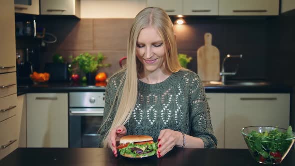 Young Lady Preferring Hamburger To Salad.