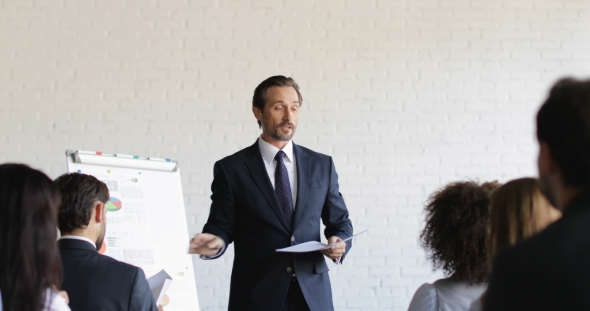 Business Man Leading Training Seminar Give Group Of Businesspeople Tests During Conference Meeting