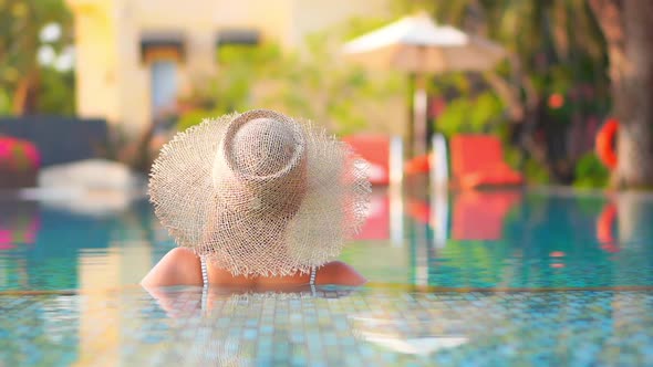 Young asian woman enjoy around outdoor swimming pool for leisure