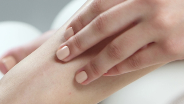 Girl Spends Her Hand Over Her Smooth Skin on Her Leg.