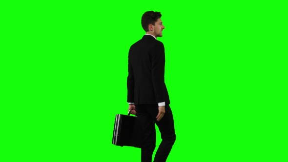 Businessman Goes To Work, with a Diplomat He Waves His Hand To Others. Green Screen