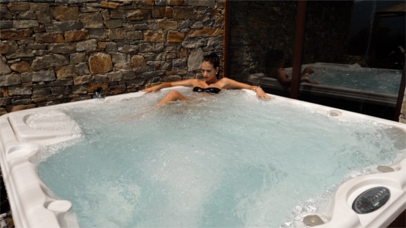 A Woman in a Luxurious Outdoor Jacuzzi