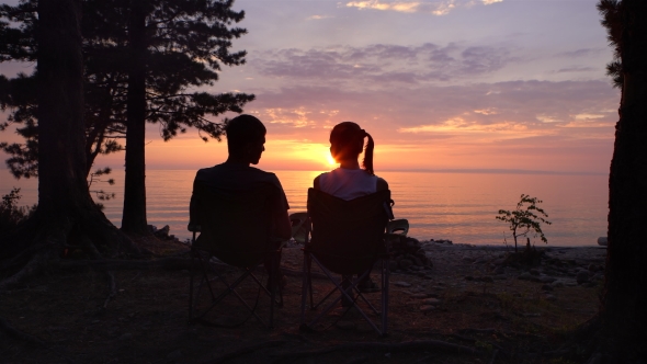 Couple Is Sitting at Campind at Night.