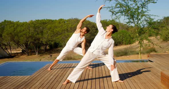 Couple performing yoga at safari vacation 4k