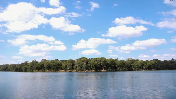 Timelapse of Clouds in a Blue Sky Next to a Lake Near Angkor Wat