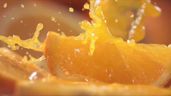 Slow Motion Shot of Orange Juice Splashing Through Orange Slices at 1400Fps