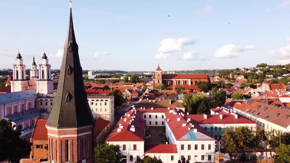 Kaunas city old town aerial drone shot while the drone is flying sideways with a beautiful church to