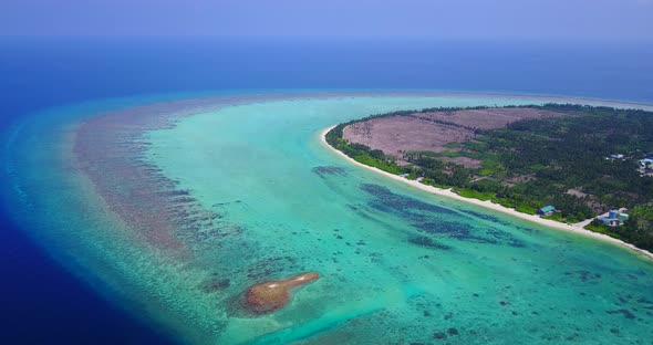 Daytime flying clean view of a sandy white paradise beach and aqua blue ocean background in high res