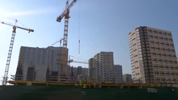 Highrise Buildings Under Construction and Cranes