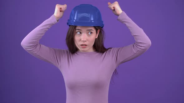 The Worried Young Woman Checks the Safety of the Blue Helmet Punches Lightly in the Helmet on Her