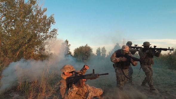 Men with Guns Walking in Smoke