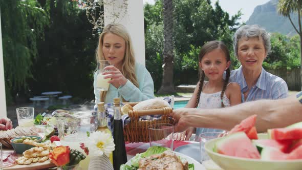 Happy family eating together at table