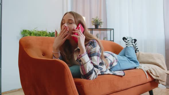 Portrait of Tired Sleepy Woman Talking on Mobile Phone with Friend Making Online Conversation Home