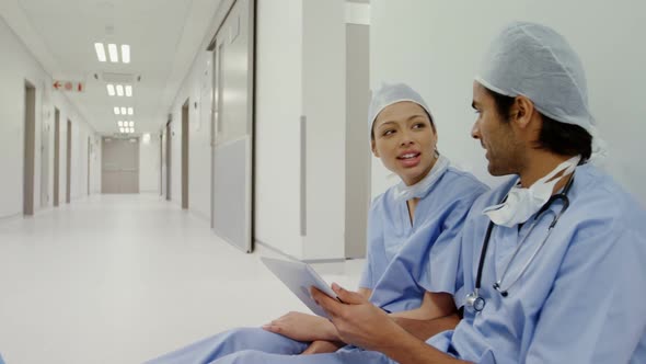 Surgeons discussing over digital tablet