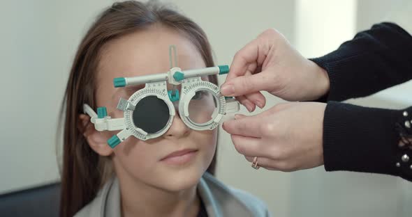 Schoolgirl Girl in a Bright Modern Optometrist's Office