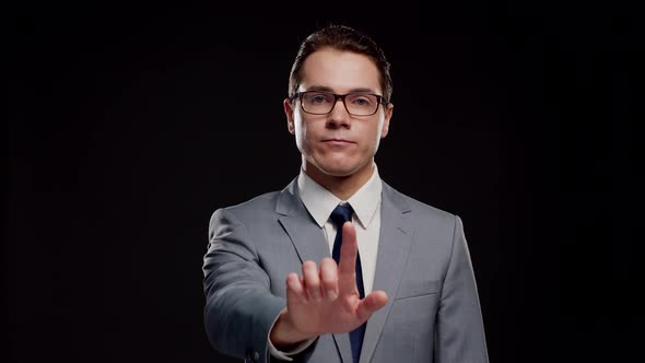 Studio portrait of successful and smart businessman in suit and tie.