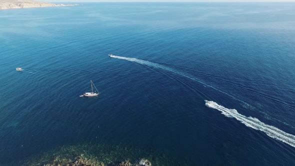 White Boat on the Blue Sea Santorini Aerial View Video of Greek Island on Sunset and in the Daylight