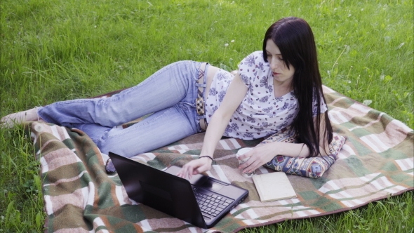 Woman Student Using Laptop in Park